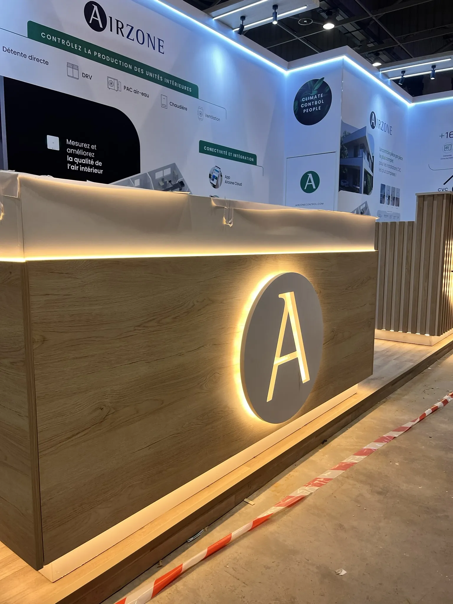Airzone booth illuminated wood reception counter