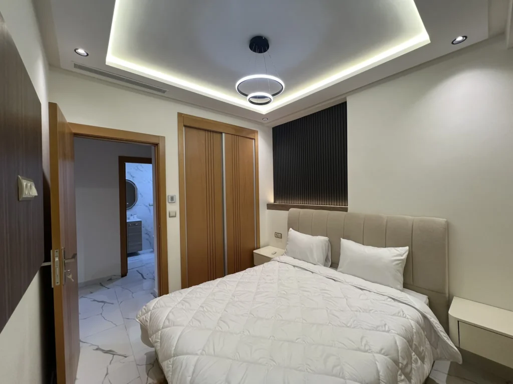 Bedroom wood sliding wardrobe ensuite marble bathroom