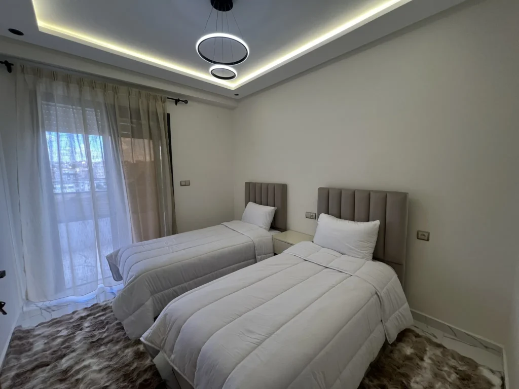 Twin bedroom beige headboards marble floor